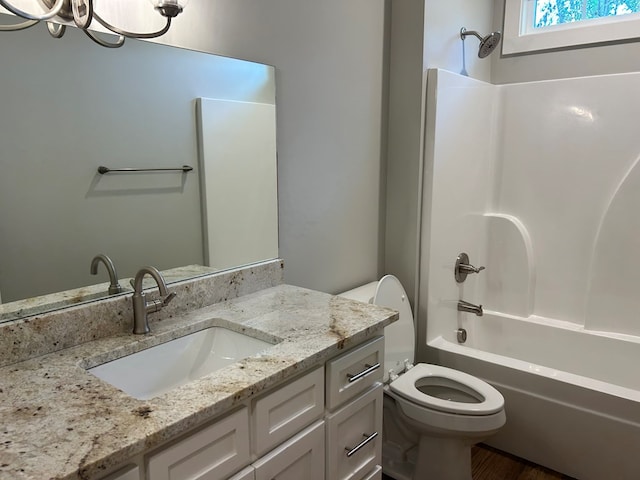 full bathroom featuring vanity, shower / bath combination, and toilet