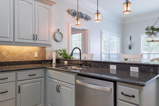 kitchen with dishwasher, dark stone countertops, ornamental molding, and sink