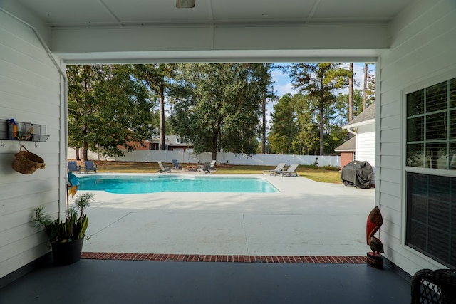 view of pool featuring area for grilling and a patio