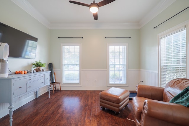 living area featuring dark wood-type flooring, crown molding, and a healthy amount of sunlight