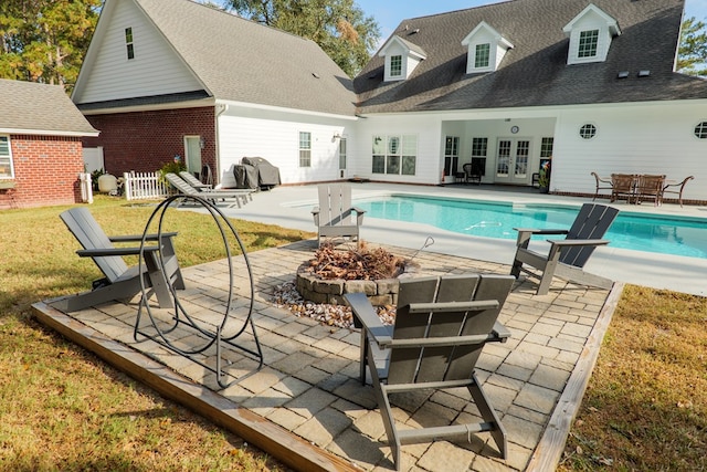 view of swimming pool with a patio area, french doors, and an outdoor fire pit