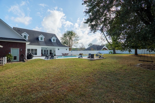 view of yard featuring a patio area and a fenced in pool