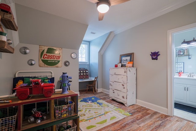 playroom featuring sink, vaulted ceiling, ceiling fan, ornamental molding, and light hardwood / wood-style floors