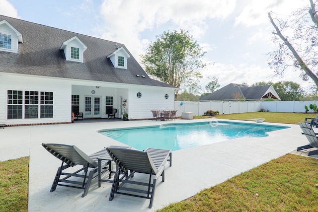 view of swimming pool with french doors, a diving board, a patio area, and a lawn