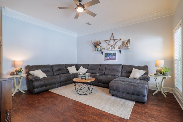 living room with dark hardwood / wood-style flooring, ceiling fan, and crown molding