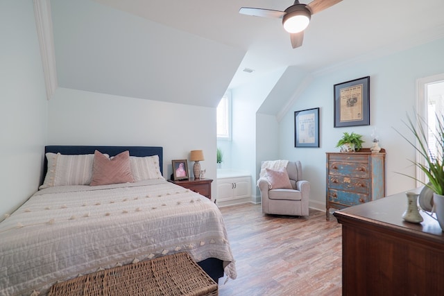 bedroom with ceiling fan, light hardwood / wood-style flooring, lofted ceiling, and ornamental molding