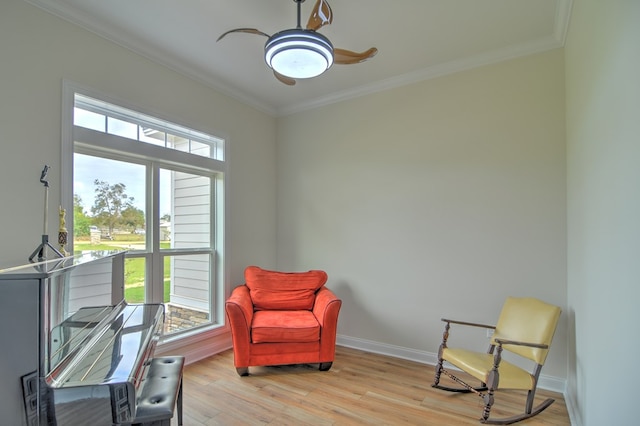 living area featuring crown molding, plenty of natural light, and light wood-type flooring