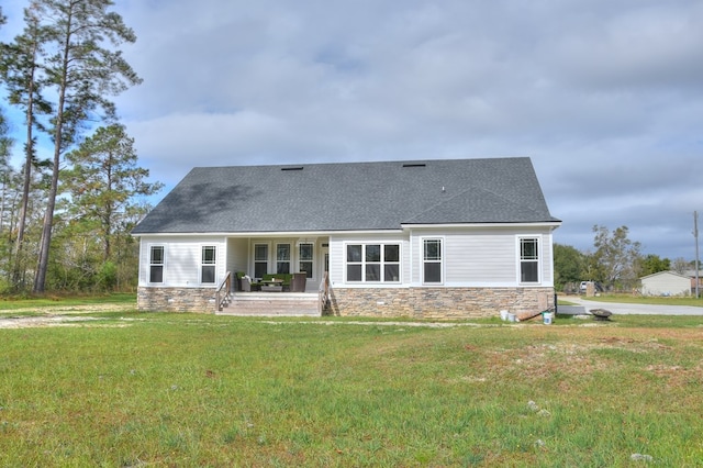 rear view of house with a yard