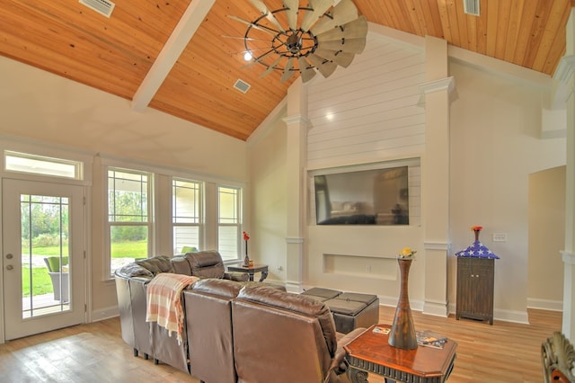 living room featuring beam ceiling, light hardwood / wood-style flooring, high vaulted ceiling, and wooden ceiling