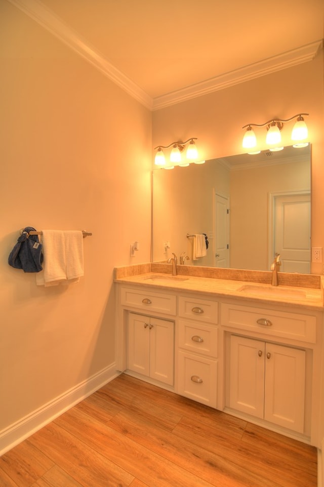 bathroom with vanity, hardwood / wood-style flooring, and crown molding