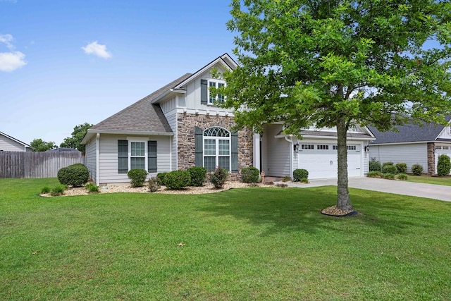 4740 Amelia Cir, Hahira, GA 31632 - view of front of house with driveway, stone siding, board and batten siding, and a garage