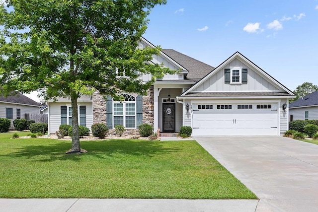 4740 Amelia Cir, Hahira, GA 31632 - view of front of house with board and batten siding, concrete driveway, a front lawn, stone siding, and an attached garage