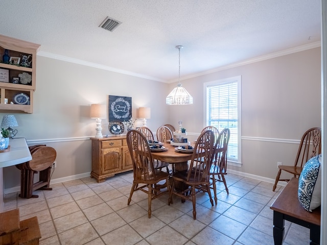 2951 Findley Chase, Valdosta, GA 31605 - dining space featuring light tile patterned flooring, visible vents, crown molding, and baseboards