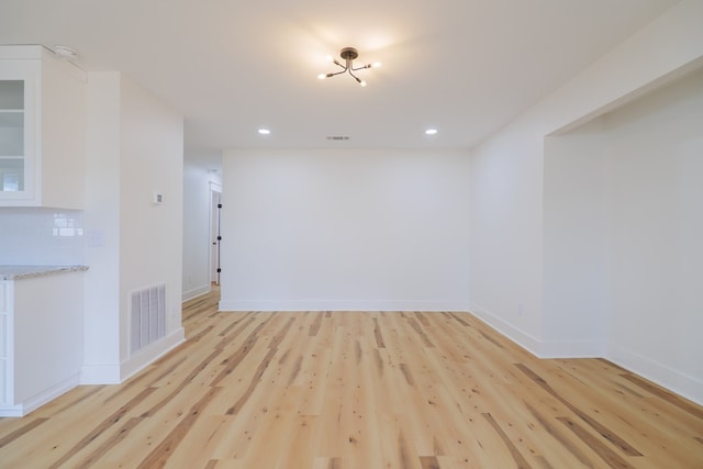 unfurnished room with light wood-type flooring