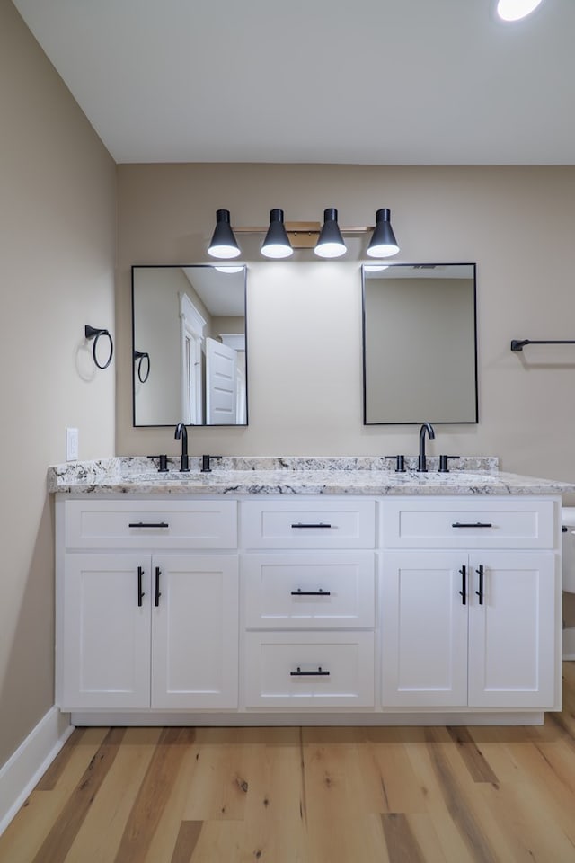 bathroom featuring vanity and hardwood / wood-style floors