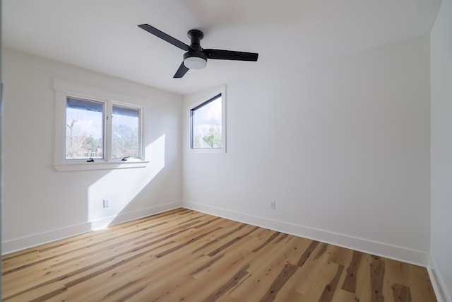 empty room with ceiling fan and light wood-type flooring