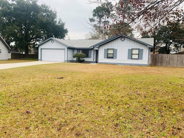 ranch-style home with a garage and a front lawn