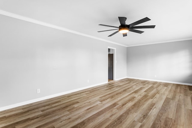 empty room featuring ornamental molding, light wood finished floors, a ceiling fan, and baseboards