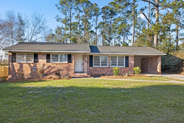 single story home with brick siding, a front yard, crawl space, an attached carport, and driveway