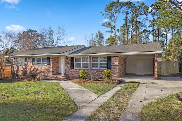 view of front of property featuring concrete driveway, an attached carport, fence, a front yard, and brick siding