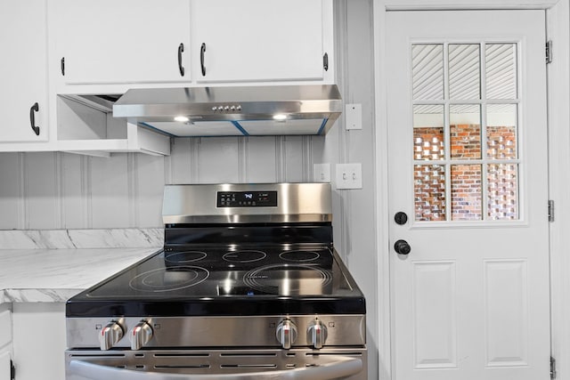 kitchen featuring white cabinets, stainless steel range with electric cooktop, and exhaust hood