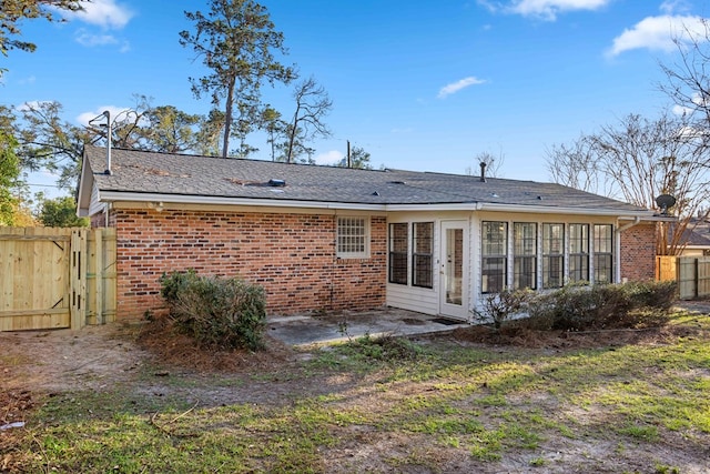 back of property featuring a patio area, brick siding, and fence