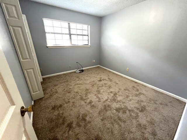 957 Mcafina Trl, Valdosta, GA 31602 - carpeted empty room featuring a textured ceiling