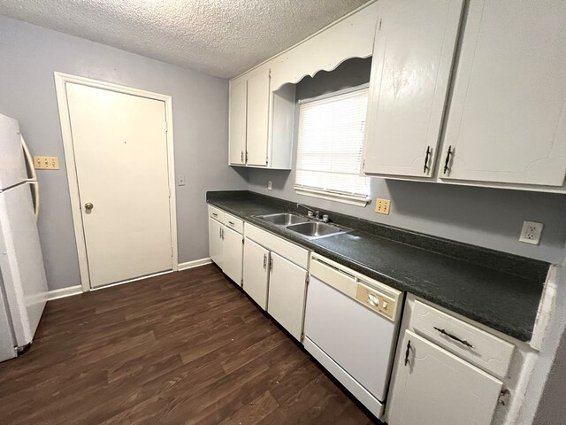 957 Mcafina Trl, Valdosta, GA 31602 - kitchen featuring sink, dark hardwood / wood-style floors, a textured ceiling, white appliances, and white cabinets