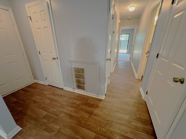 957 Mcafina Trl, Valdosta, GA 31602 - hallway with a textured ceiling and light hardwood / wood-style flooring