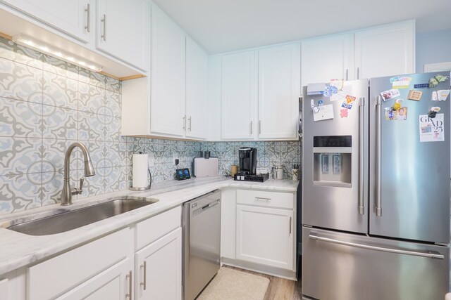 4604 Rustic Ridge Rd, Valdosta, GA 31602 - kitchen featuring stainless steel appliances, tasteful backsplash, and white cabinets