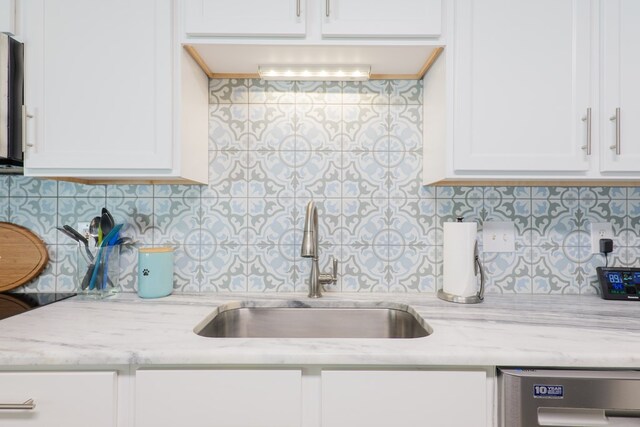 4604 Rustic Ridge Rd, Valdosta, GA 31602 - kitchen featuring backsplash, white cabinetry, dishwasher, and light stone countertops