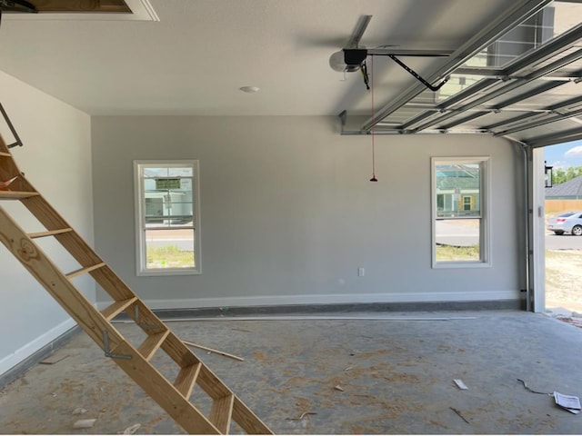 3864 Lu Ln, Hahira, GA 31632 - garage featuring baseboards and a garage door opener