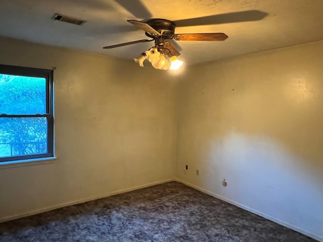 carpeted spare room with ceiling fan