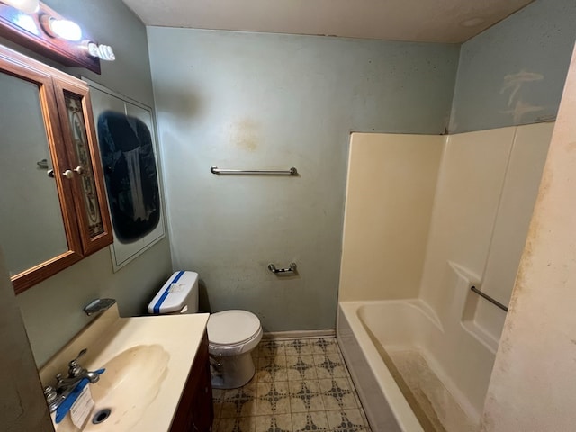 bathroom with a bath, vanity, and toilet