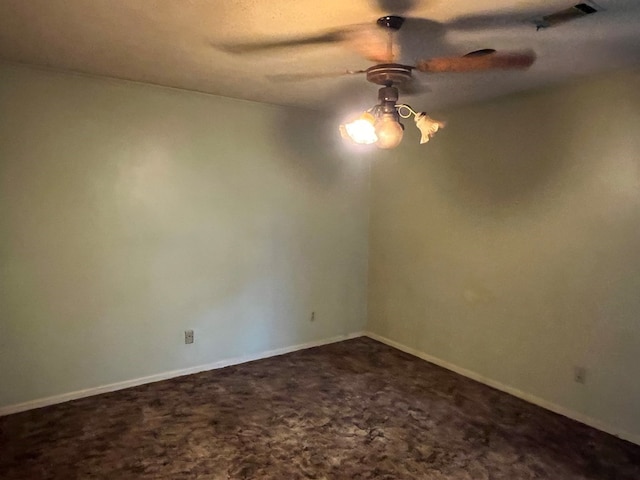 spare room featuring ceiling fan and carpet floors