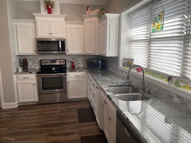 4686 Rudy Way, Hahira, GA 31632 - kitchen with stainless steel appliances, a sink, healthy amount of natural light, and white cabinets