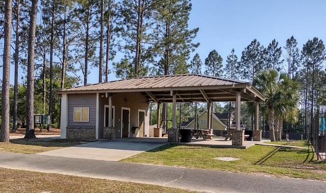 4686 Rudy Way, Hahira, GA 31632 - view of community with driveway, an attached carport, and a lawn