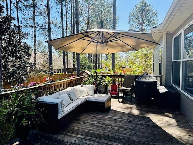 wooden terrace with an outdoor living space and fence