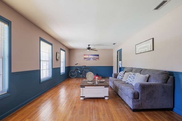 living room with ceiling fan, a healthy amount of sunlight, and hardwood / wood-style flooring