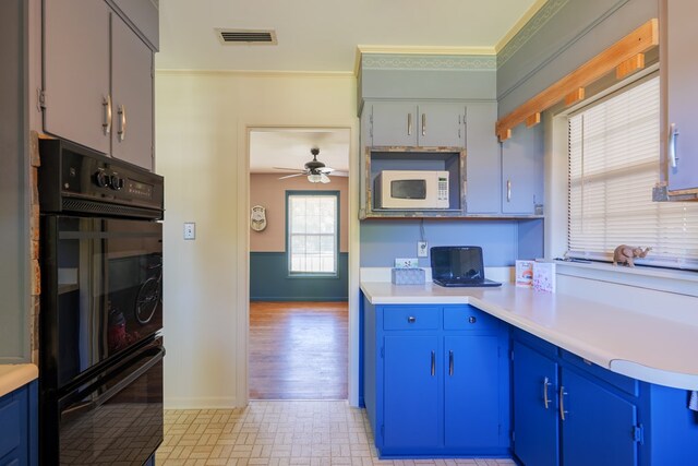 kitchen featuring blue cabinets, black double oven, ceiling fan, ornamental molding, and light hardwood / wood-style floors