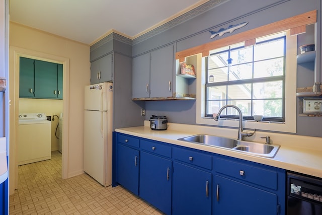 kitchen with a wealth of natural light, sink, white refrigerator, and washer / dryer