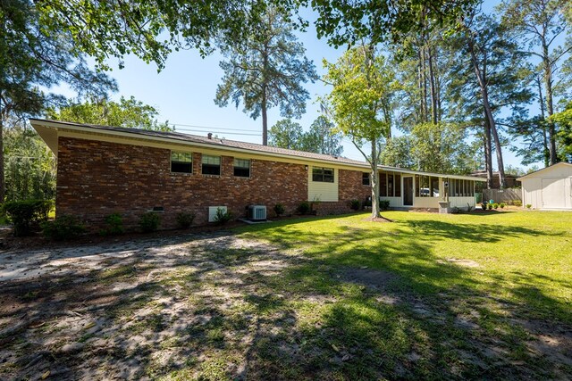 back of property with a yard and cooling unit