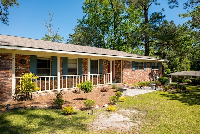 ranch-style home with a porch and a front lawn