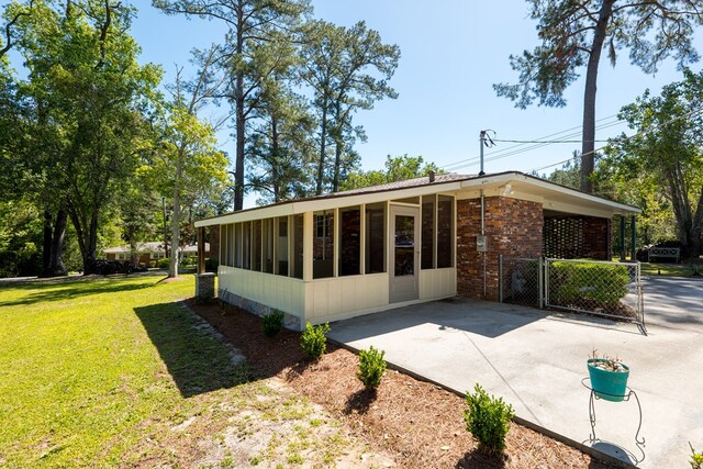 exterior space featuring a lawn and a patio