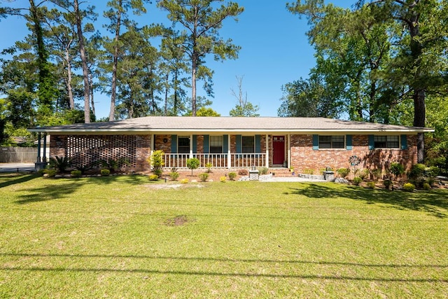 ranch-style house with a porch and a front lawn