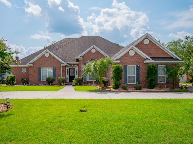 view of front of house with a front lawn and brick siding