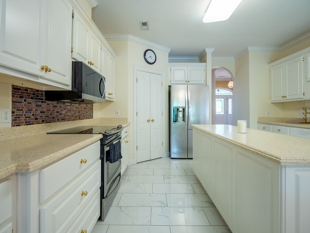 kitchen with arched walkways, ornamental molding, appliances with stainless steel finishes, white cabinetry, and marble finish floor