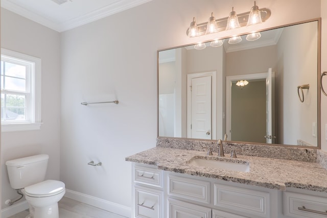 bathroom with vanity, toilet, and crown molding