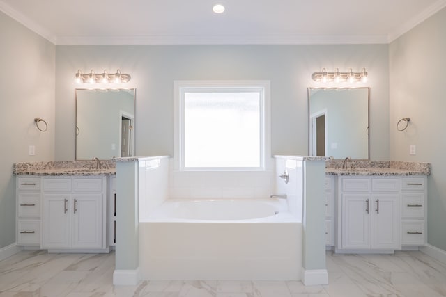 bathroom featuring a bathing tub, vanity, and ornamental molding