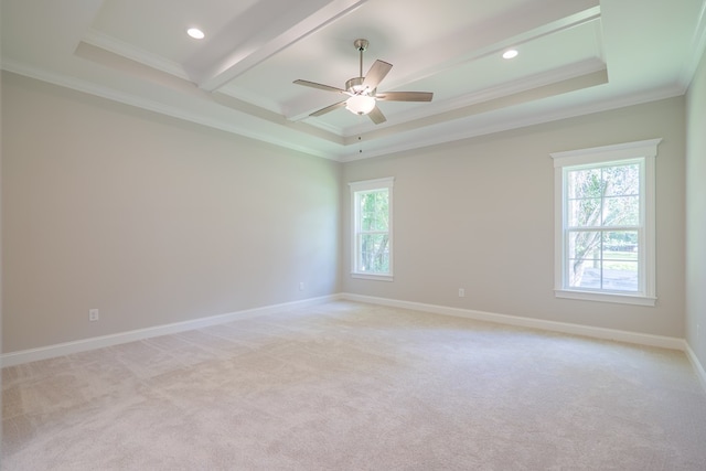 carpeted spare room featuring ceiling fan, a healthy amount of sunlight, and ornamental molding